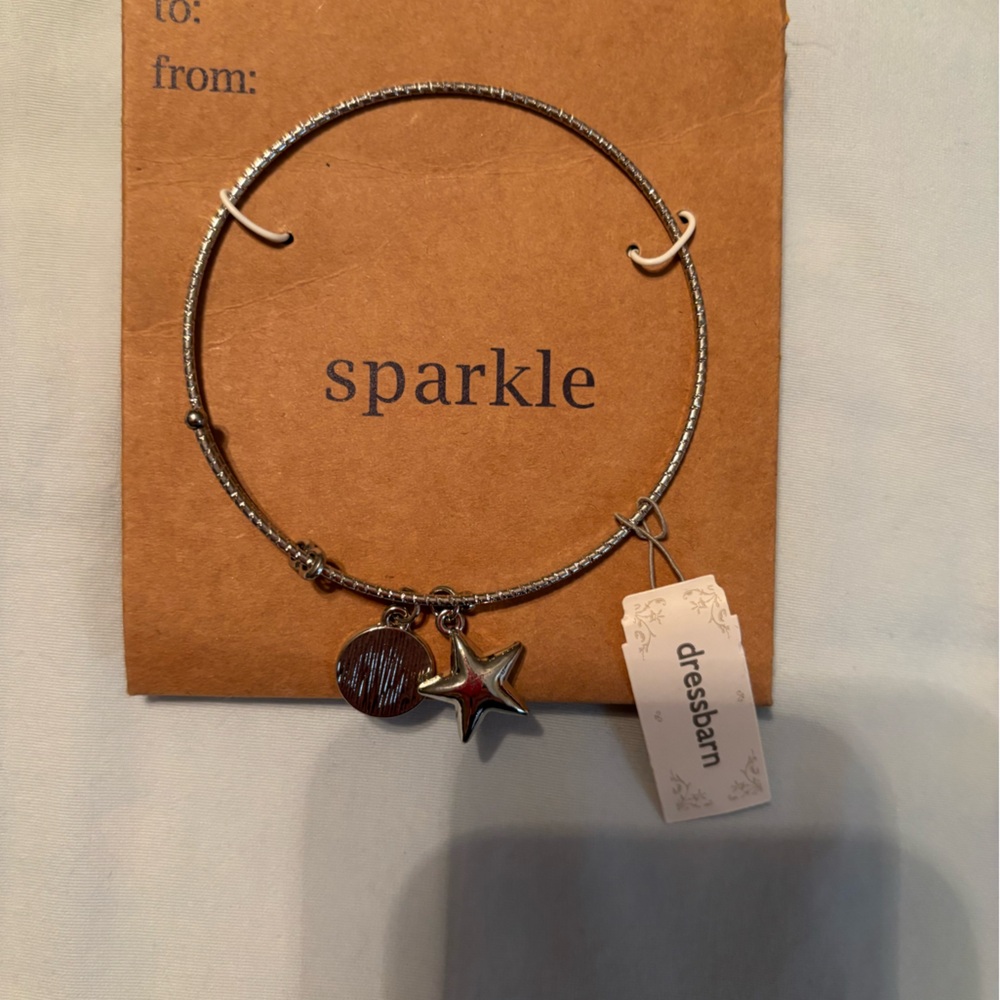 Brand new silver bracelet with charm.